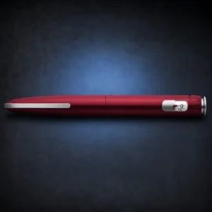 Red HumaPen Savvio manual reusable pen on a dark navy background